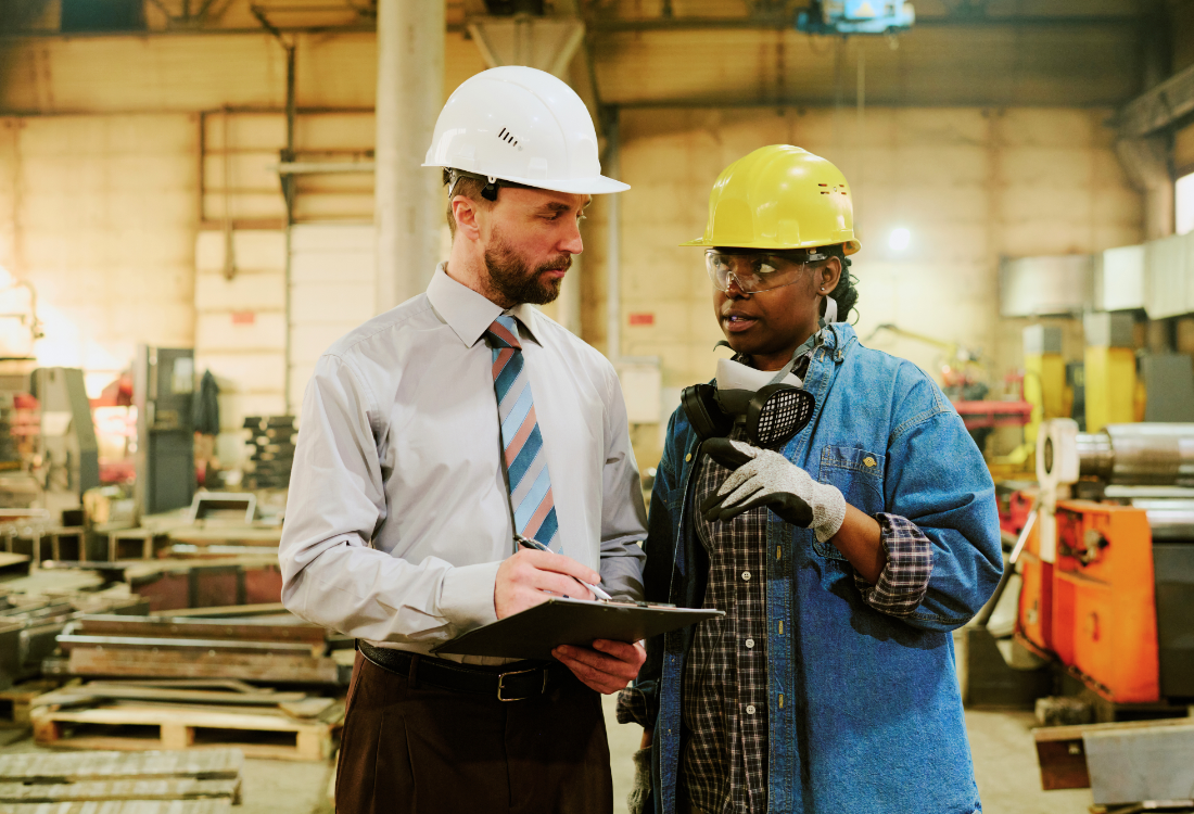 Engineer and technician discussing ROI on investment made towards machinery.