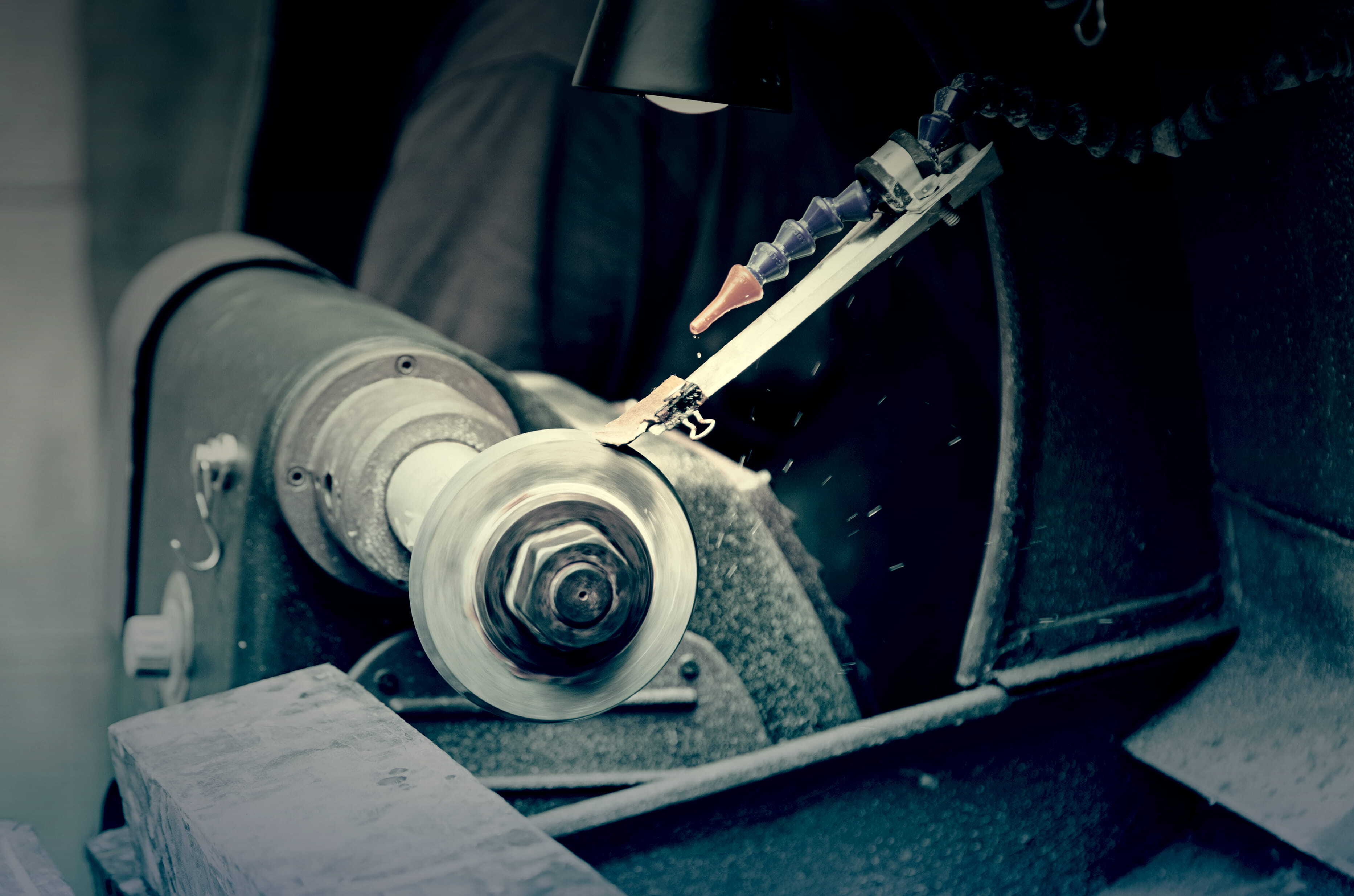 Metal surface finishing machinery using a rotating abrasive wheel to finish and polish metal. 