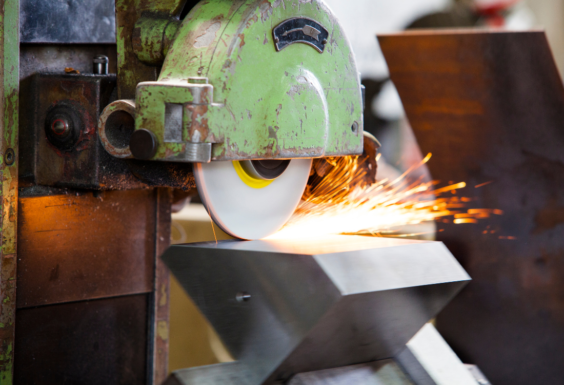 Automated metal surface finishing machine grinding and polishing metal. 